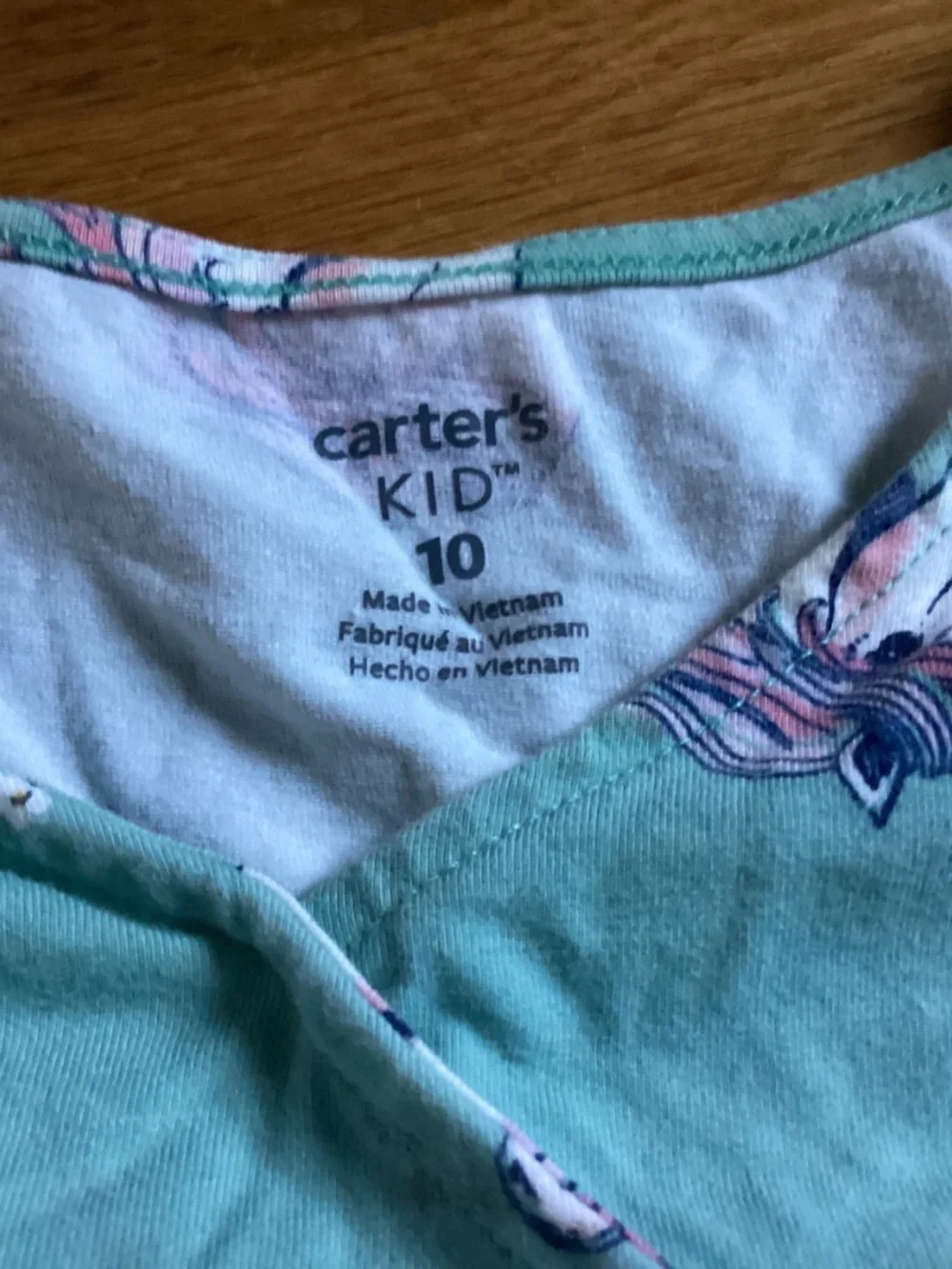 A Carter’s kid size 10 sage green dress with unicorns
